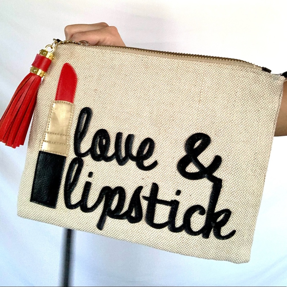 Love & Lipstick burlap purse with red tassel and shoulder strap.